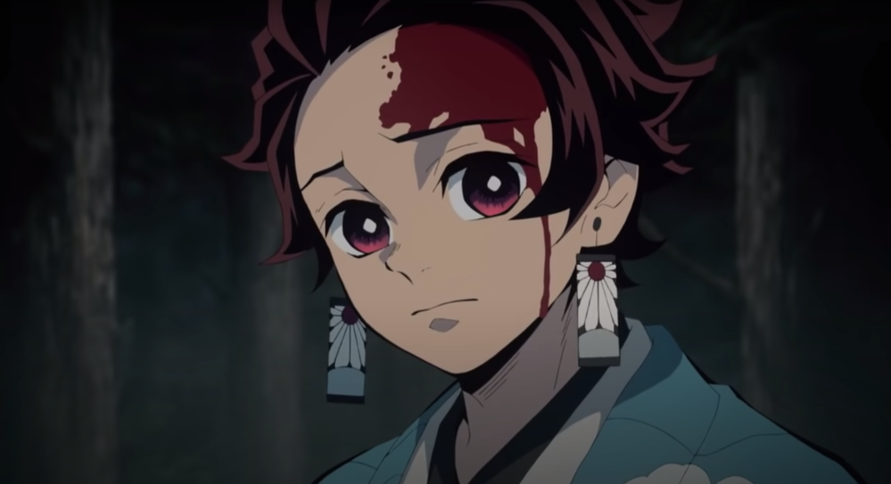 Screengrab of Tanjiro with a sad look on his face, looking at the camera, but it's implied that he's looking towards something that is behind the viewer.