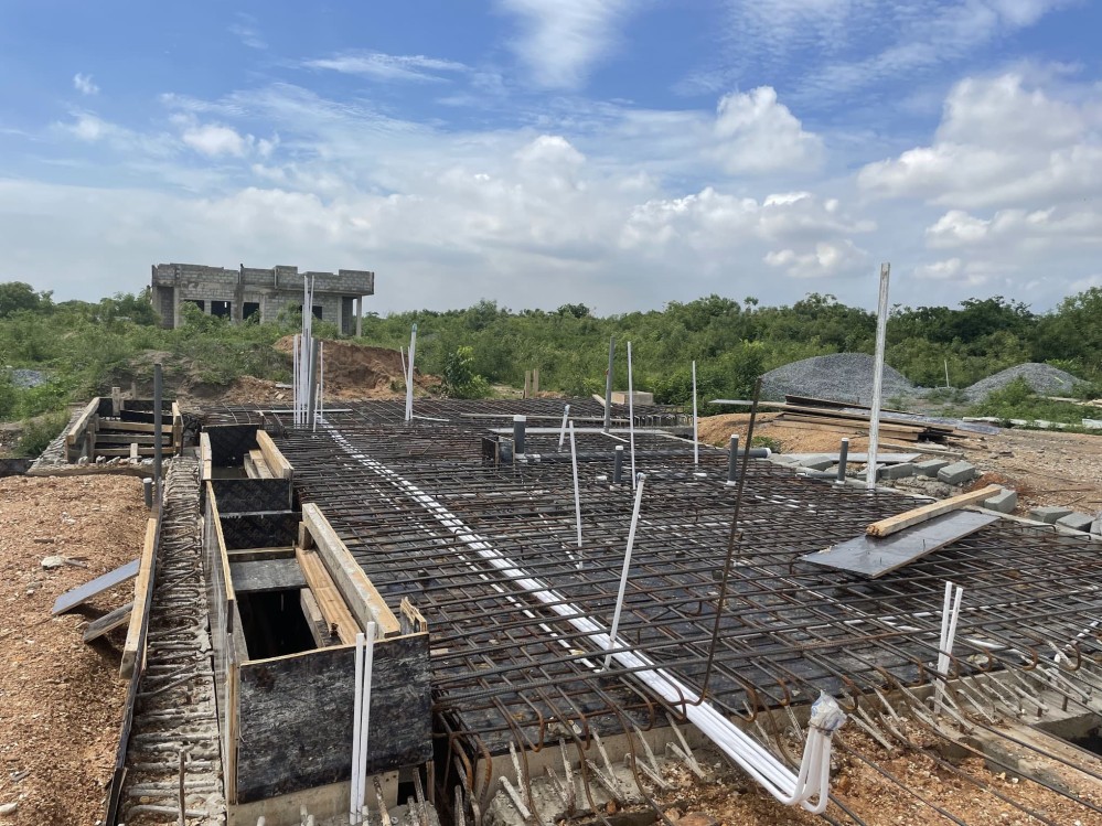 Hundreds of iron rods cover the ground, a few days before being cast