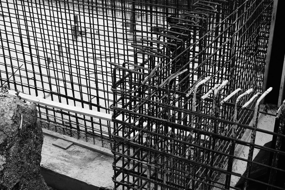 Close-up black and white shot of a forest of iron rods