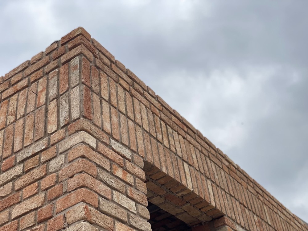 The corner of a brick buildings roofline