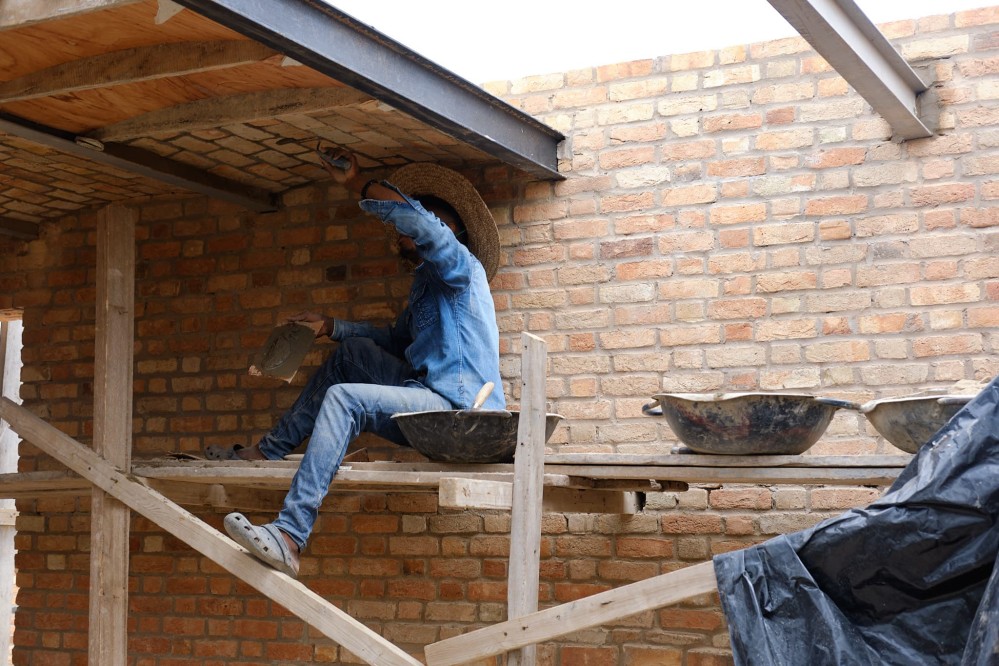 Another view of worker completing the barell-vaulted brick ceiling