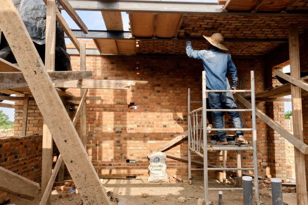A bricklayer completes the barell-vaulted brick ceiling