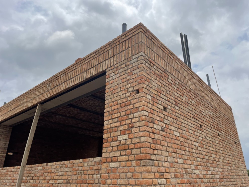 Close-up of the corner of the brick building with a wide window