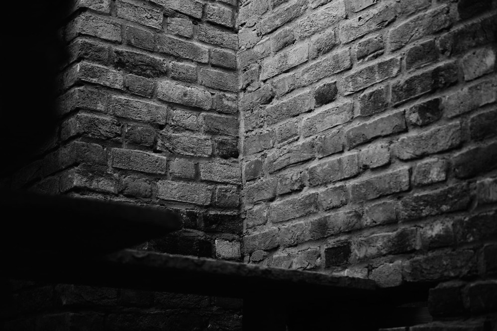 Black and white close-up of the inside corner of a brick wall