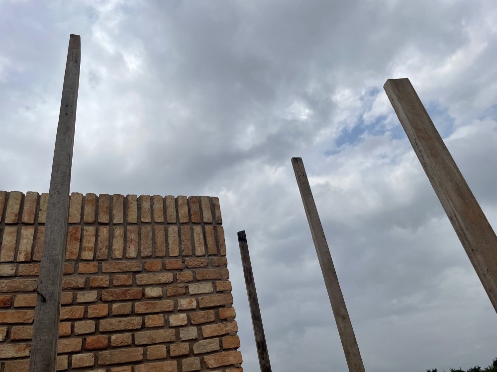 Corner of a brick building against an overcast sky