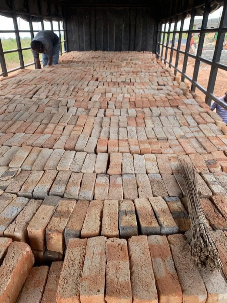Several light brown bricks arranged carefully in the bed of a truck, about to be delivered.
