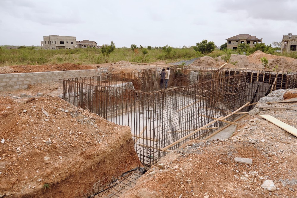 Wide shot showing the forest of iron rods coming out of the basement excavation