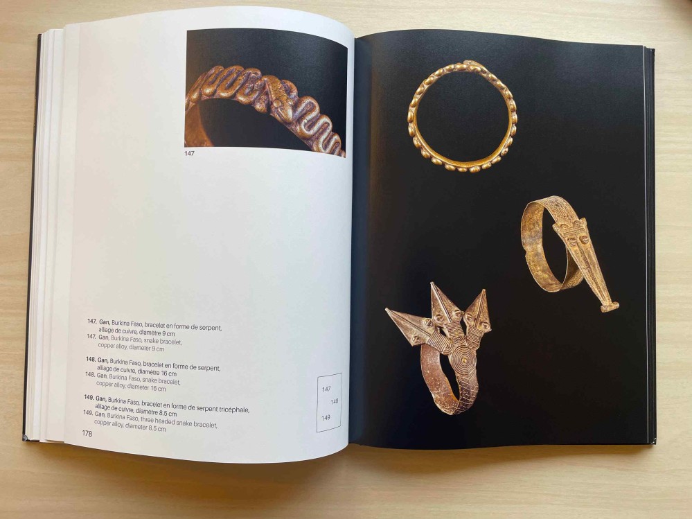 Inside pages of Metalworking in West Africa. There are four metal bracelets, and text explaining what each one is