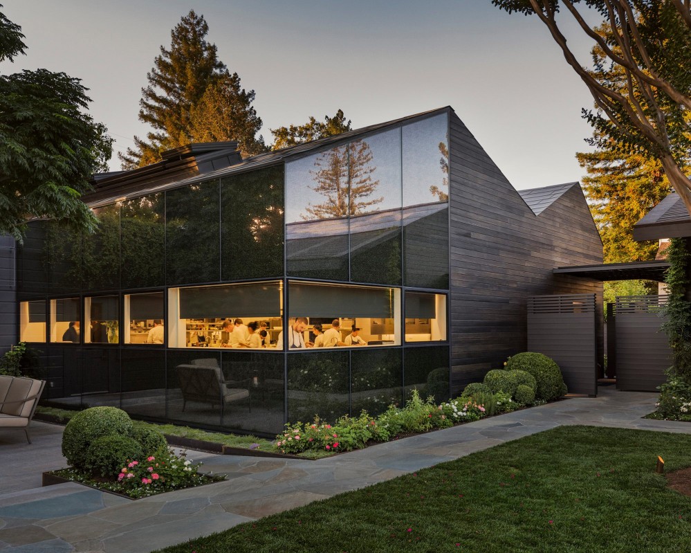 Photo of The French Laundry. It's a gabled rood structure made of wood and glass.