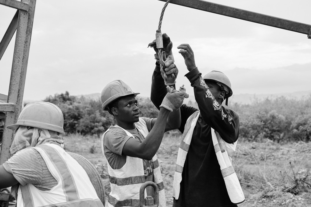 Two men setting up cables