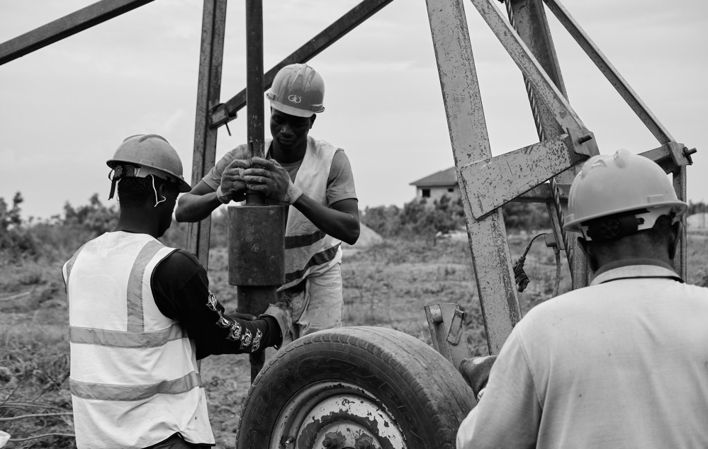Two men opreating the drilling machine